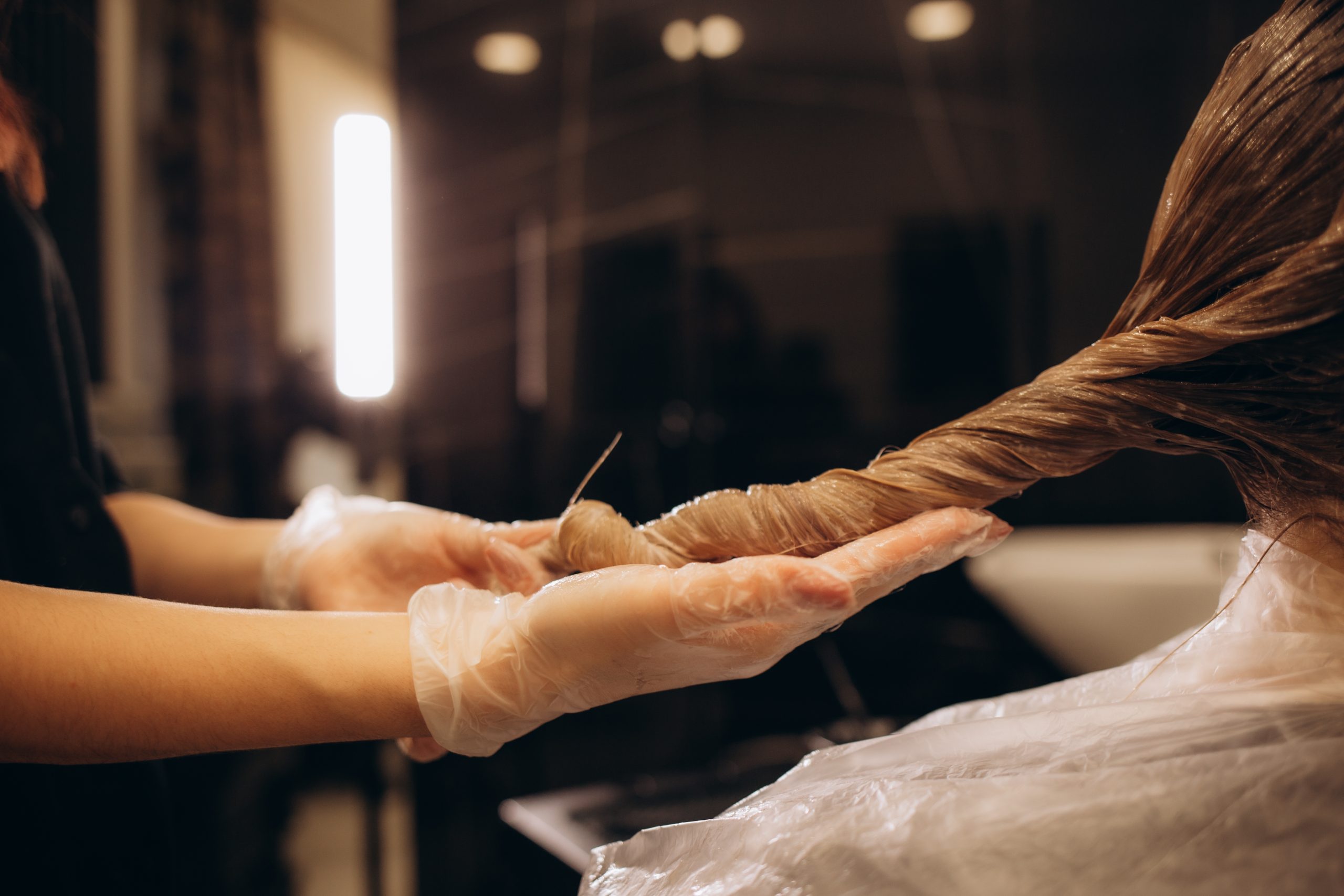 The,Hairdresser,Dyeing,Blonde,Hair,Roots,With,A,Brush,For