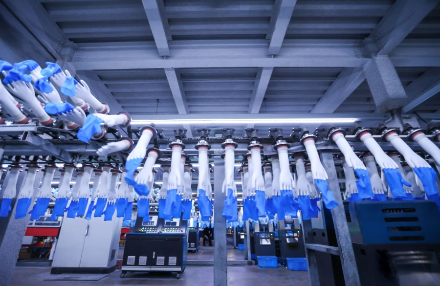 Disposable Gloves in a factory production line scene, being processed and manufactured.