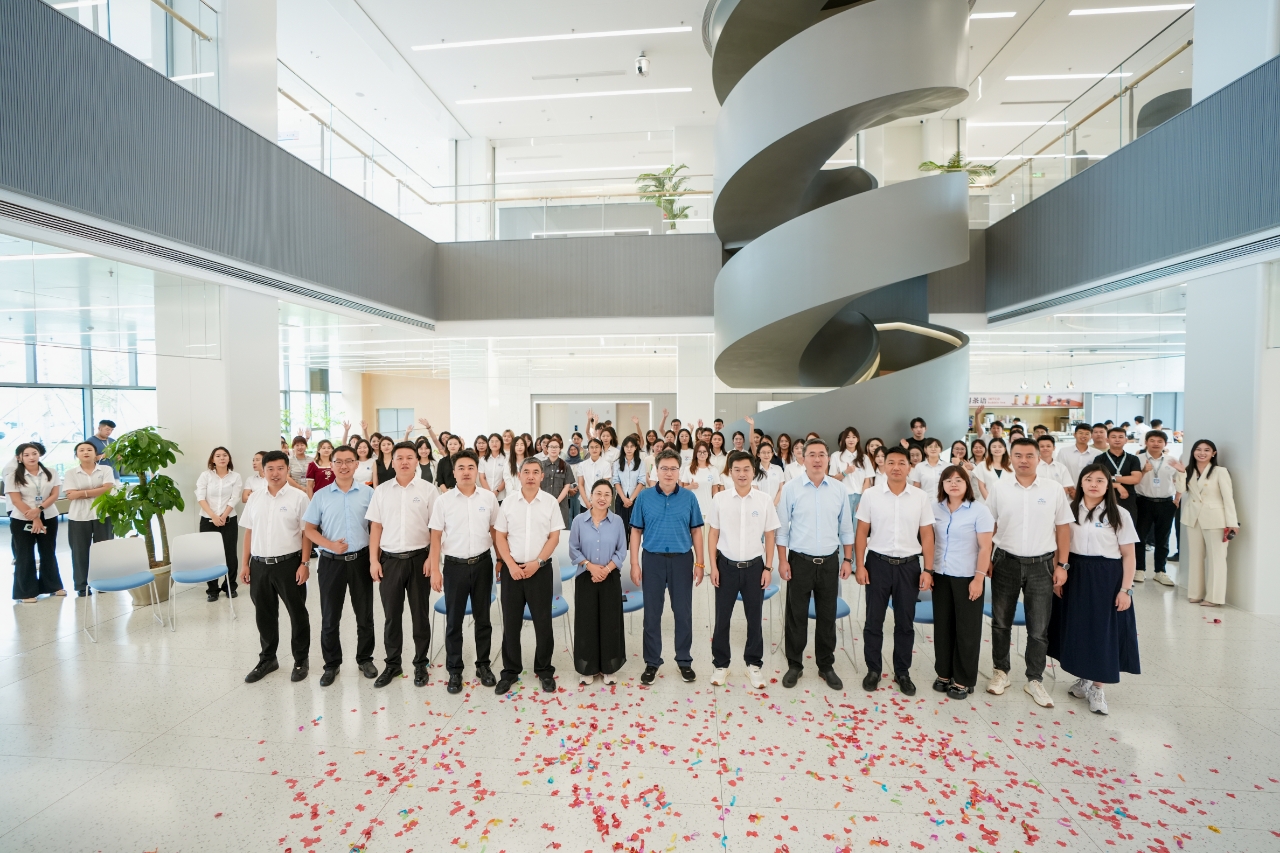 "INTCO Medical team celebrating in modern office lobby"